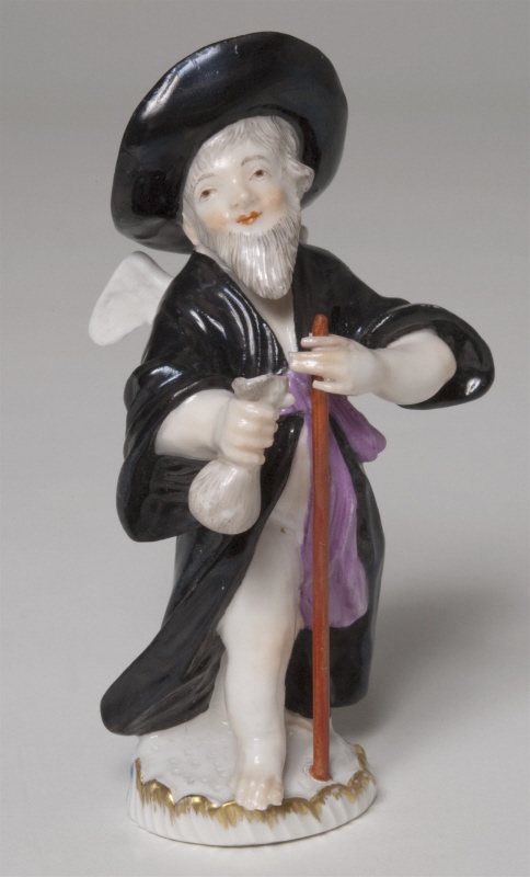 Figurin, bevingad putto som vandringsman i hatt och lösskägg