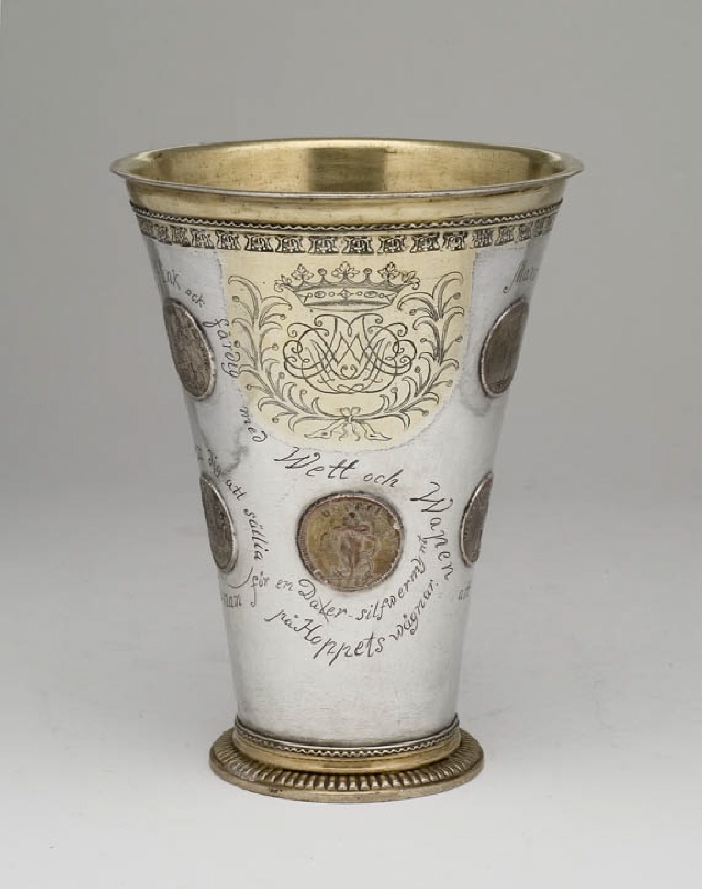 Cup decorated with mirror monogram and emergency coins