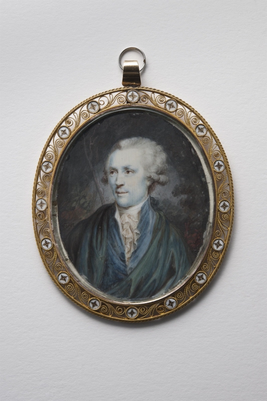 Portrait of young man in blue cloak