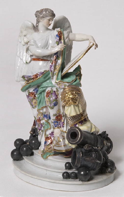 Figurine ”Genius with wings and ammunition and canons”