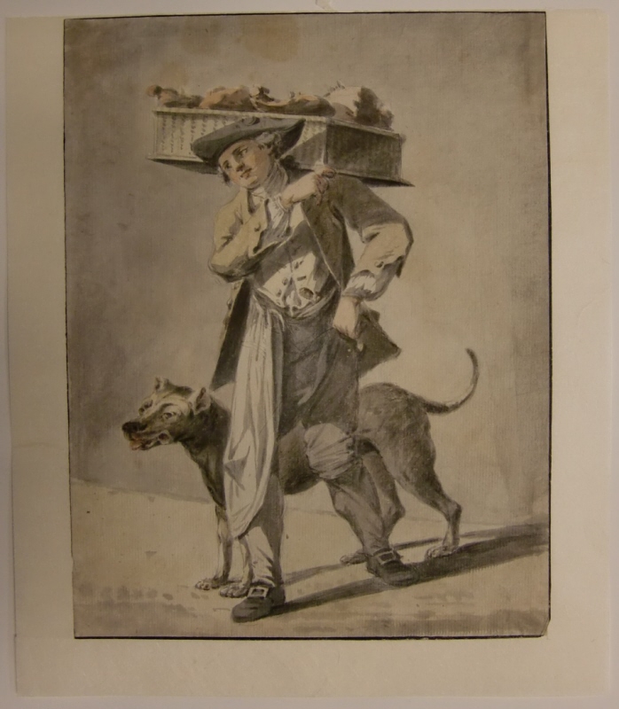 Ung slaktare, som bär en korg på axel, med hund