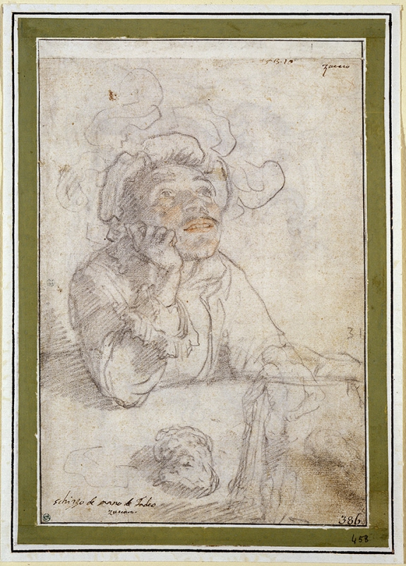 A man in a plumed hat sitting at a table