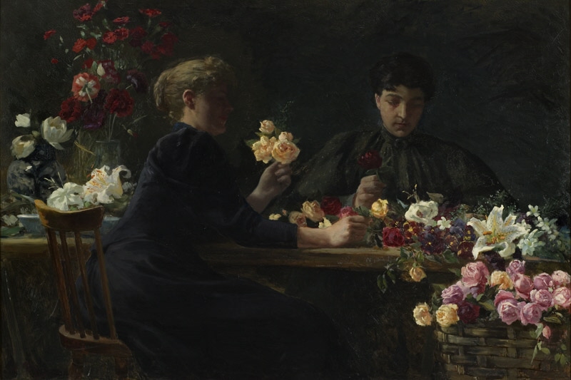 Damer vid ett blomsterbord