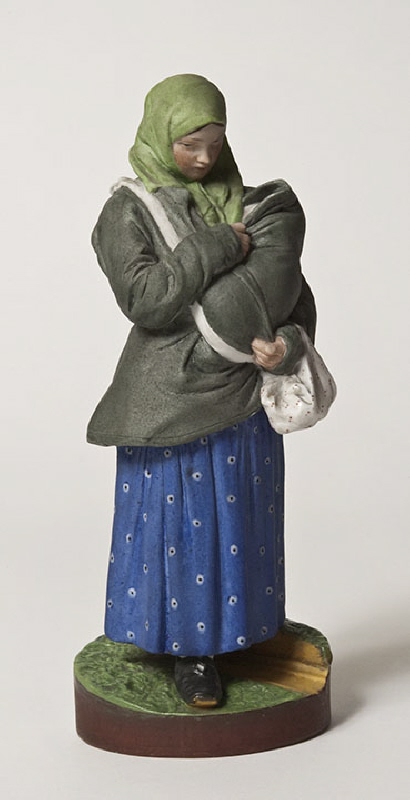 Figurin, bondkvinna med ett barn på bröstet
