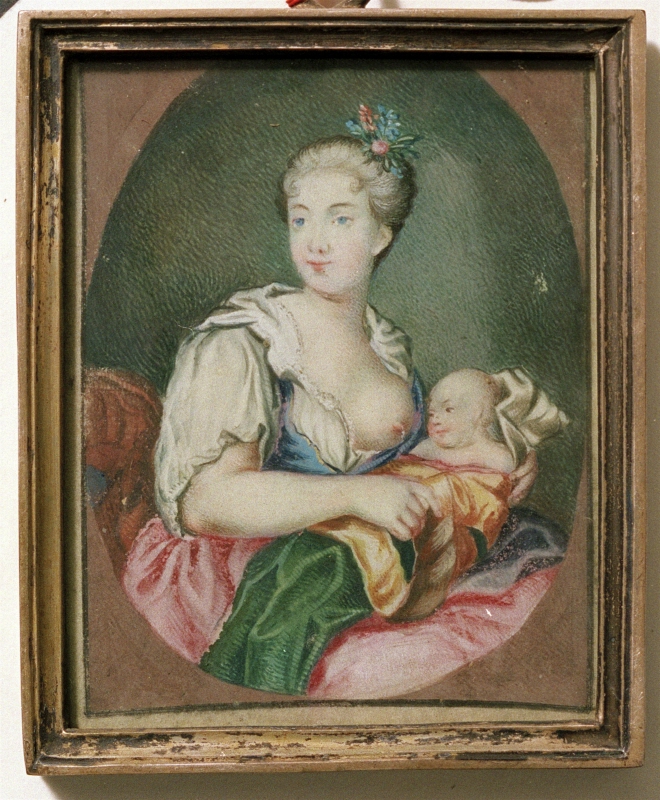 Kvinna med dibarn vid bröstet
