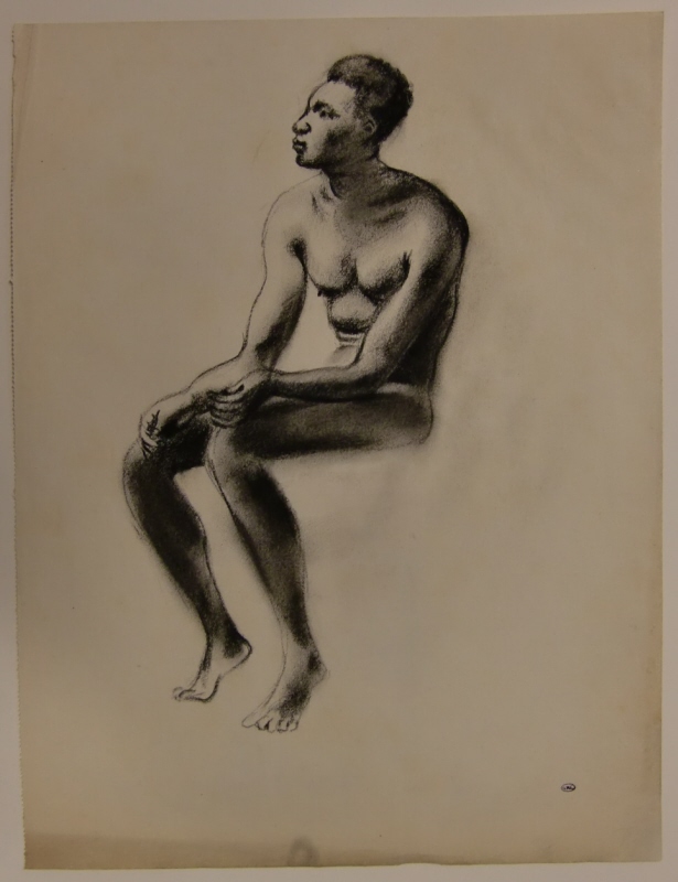 Sittande manlig naken modell
