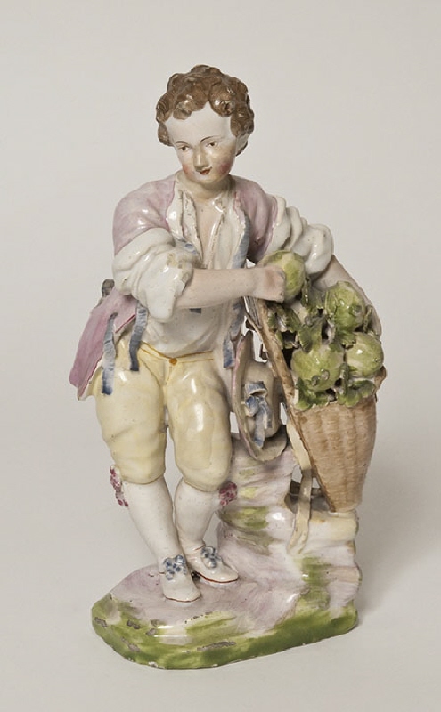 Figurin av fajans föreställande en melonförsäljande gosse