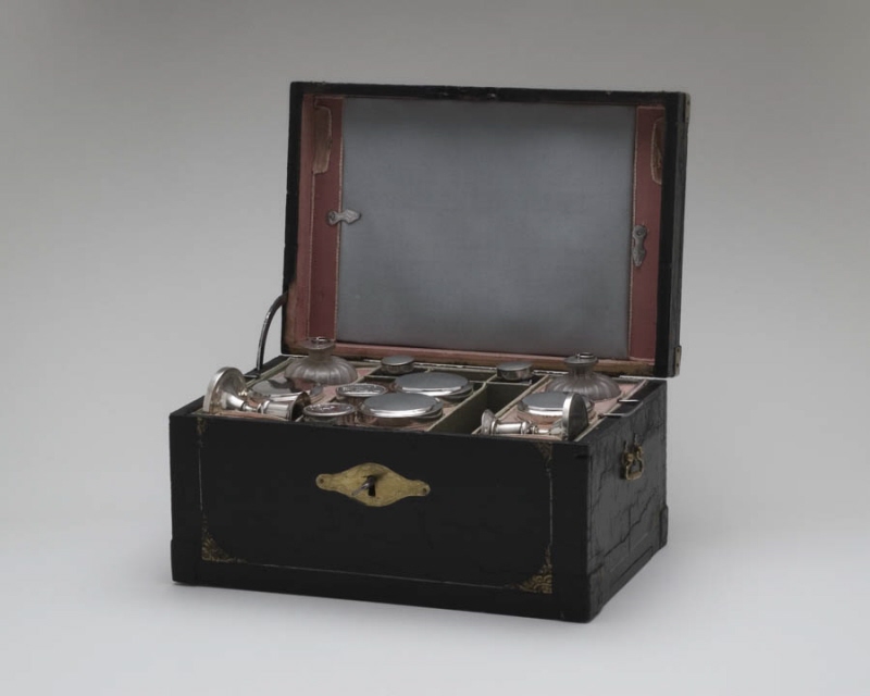 Travel case with candlesticks, bottles, writing equipment, boxes